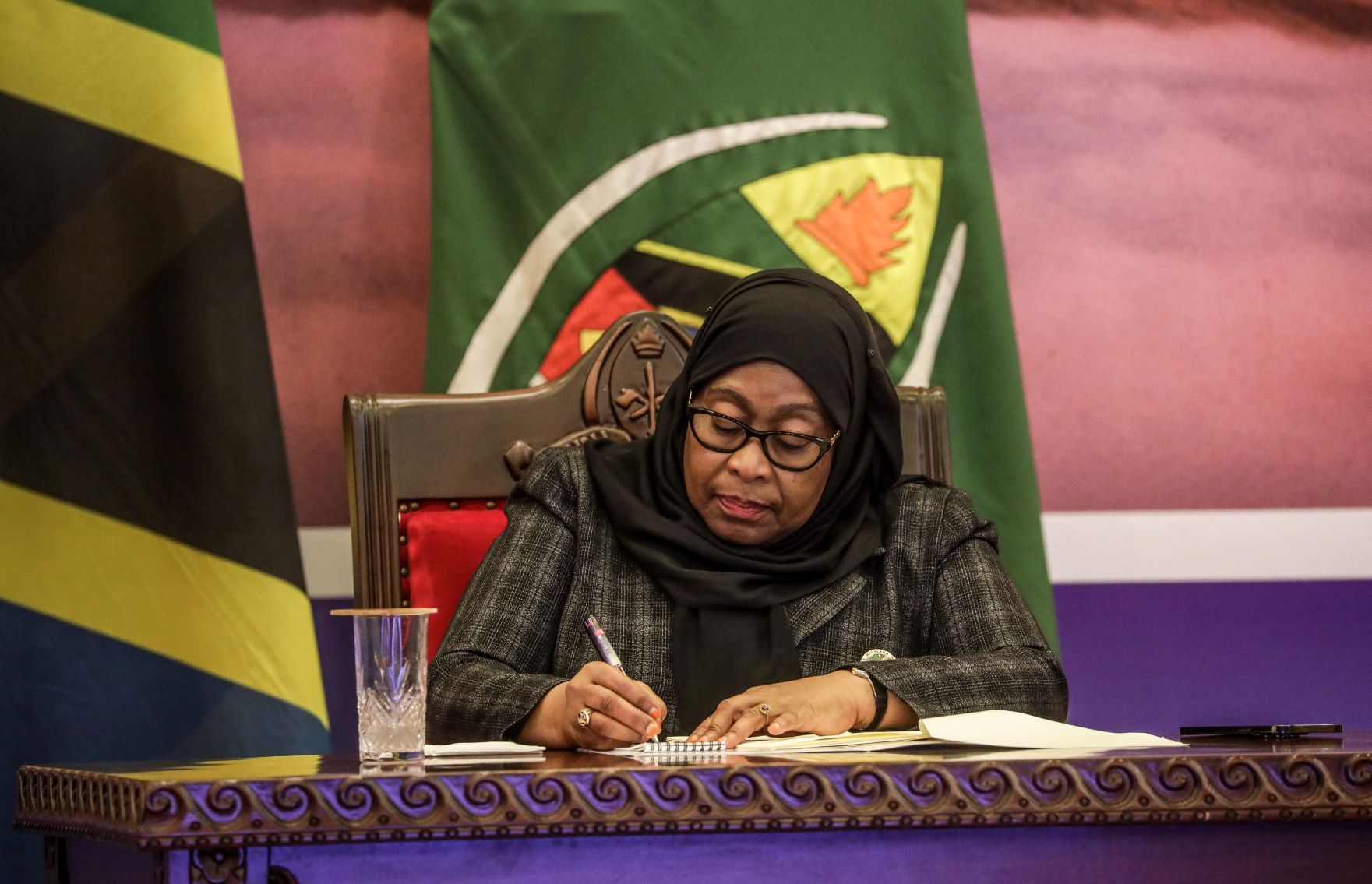 Tanzania's President Samia Suluhu Hassan taking notes as she attend a meeting with the senior government officials at State House in Dar es Salaam on January 04, 2022. Editorial credit: Ericky Boniphace / Shutterstock.com